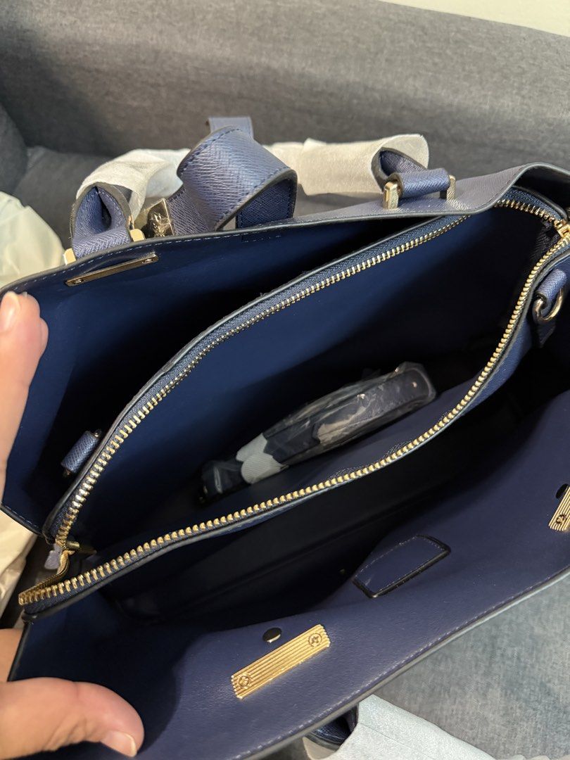 Dune London Navy Blue Handbag (Category: Shoulder Bags) located in Quezon City. Submitted by pam07pam (Listing ID 1469480414, Image 2). Description: - Brand: Dune London - Color: Deep blue - Original Price: Php 7,000 - Material: Textured faux leather with gold-tone hardware and front brand plaque - Condition: Brand new with tags attached - Handles: Double top handles with original protective foam - Strap: Includes matching adjustable shoulder str