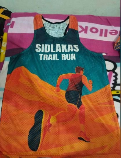 Eagles Fun Run 2025 and Sidlakas Trail Run Singlets (Category: Activewear) located in Cebu City. Submitted by youngjus27 (Listing ID 1469433026, Image 1). Description: - Set of 2 running singlets for road and trail - Eagles Fun Run 2025 event shirt with blue city skyline graphic and sponsor logos - Sidlakas Trail Run 7KM finisher jersey with vibrant orange and green mountain design - Lightweight and breathable mesh fabric to keep you cool - Comfo