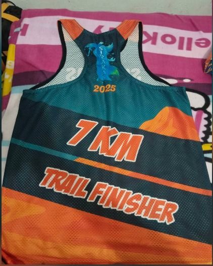 Eagles Fun Run 2025 and Sidlakas Trail Run Singlets (Category: Activewear) located in Cebu City. Submitted by youngjus27 (Listing ID 1469433026, Image 2). Description: - Set of 2 running singlets for road and trail - Eagles Fun Run 2025 event shirt with blue city skyline graphic and sponsor logos - Sidlakas Trail Run 7KM finisher jersey with vibrant orange and green mountain design - Lightweight and breathable mesh fabric to keep you cool - Comfo
