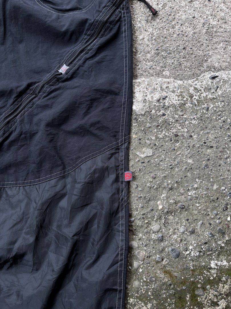 Ecko Function Nylon Cargo Pants Black Size L (Category: Joggers) located in Manila. Submitted by thrifttika (Listing ID 1469445713, Image 2). Description: - Brand: Ecko Function - Size: Large - Color: Black - Material: Durable ripstop nylon fabric with comfortable orange mesh lining - Design: Multiple utility zippers down the legs and detailed contrast stitching - Fit: Adjustable drawstrings at the leg openings - Details: Branded zipper pulls and