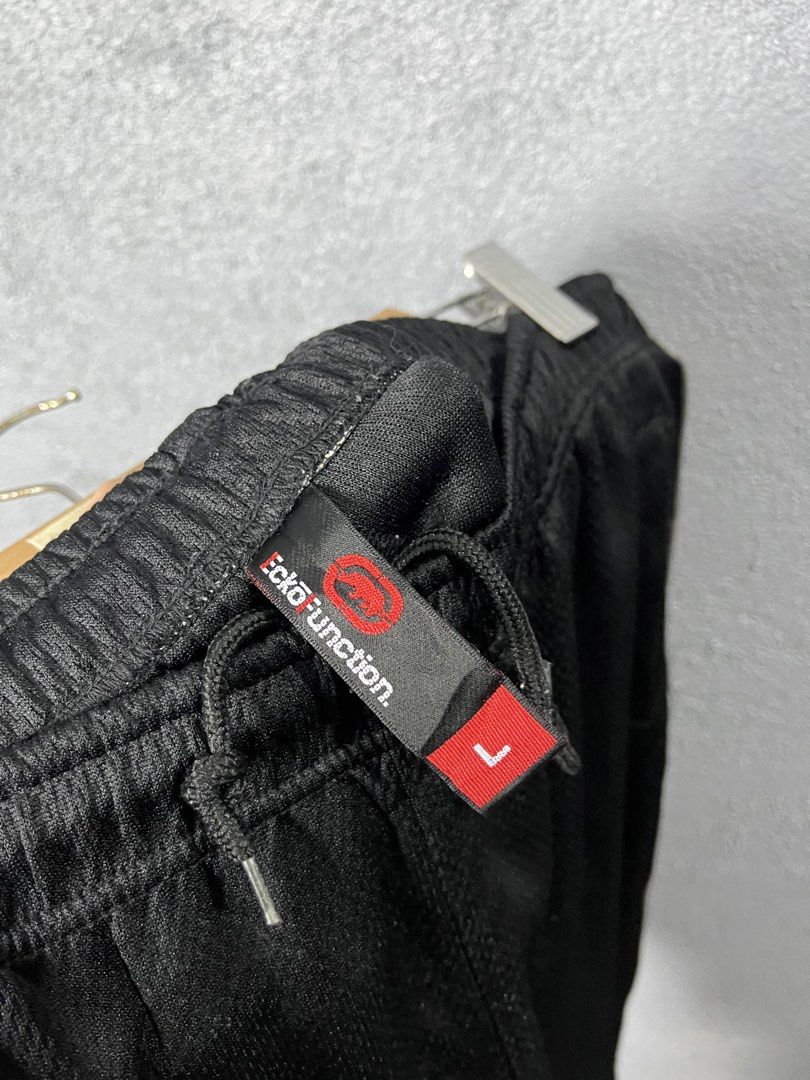 Ecko Unltd Ecko Function Black Mesh Shorts Size L (Category: Shorts) located in Famy. Submitted by basicthrifted (Listing ID 1469404733, Image 3). Description: - Brand: Ecko Function - Size: Large - Color: Black - Material: Breathable athletic mesh - Waistband: Elastic with drawstring closure - Pockets: Convenient side pockets - Details: Bold logo side taping and embroidered rhino logo on lower left leg - Condition: Excellent / Ready to wear.