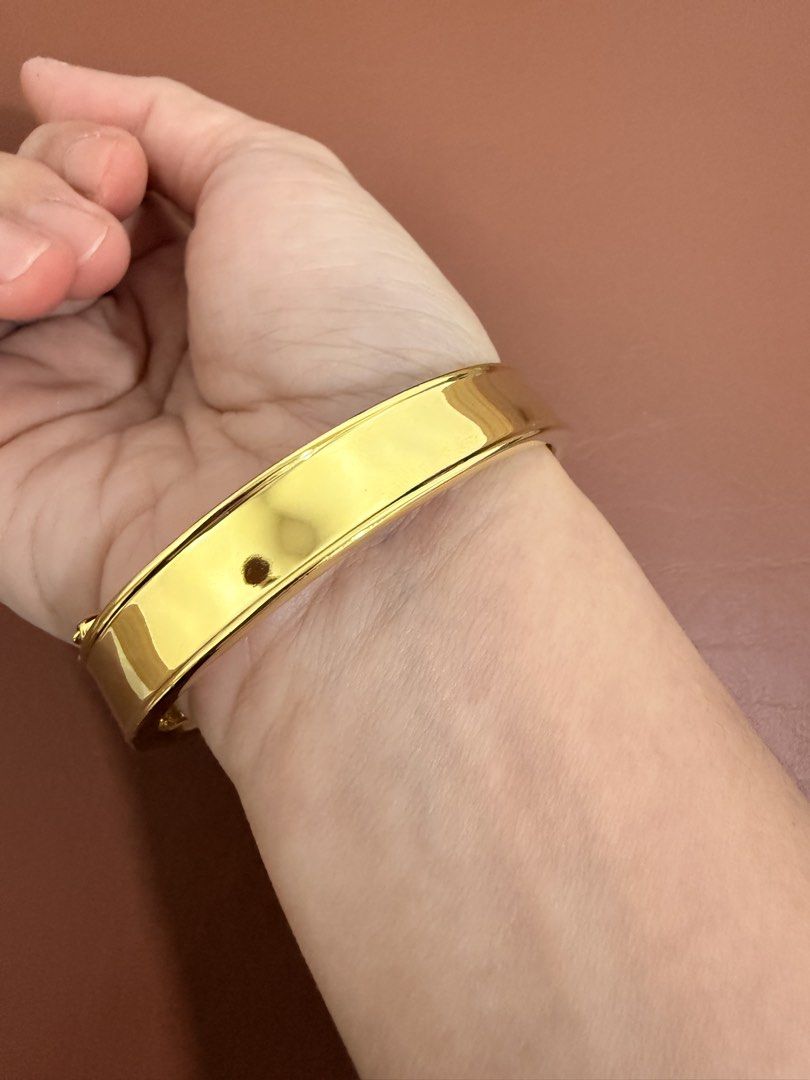 ESCADA Gold Tone Rhinestone Cutout Bangle Bracelet (Category: Bracelets) located in Quezon City. Submitted by anille (Listing ID 1469555248, Image 2). Description: - Elegant gold tone bangle bracelet with a chic cutout pattern - Embedded sparkling rhinestones between stations for extra shine - Textured back half design with a secure hinge clasp closure - Inner circumference measures approximately 7 inches - Features a shiny polished finish with m