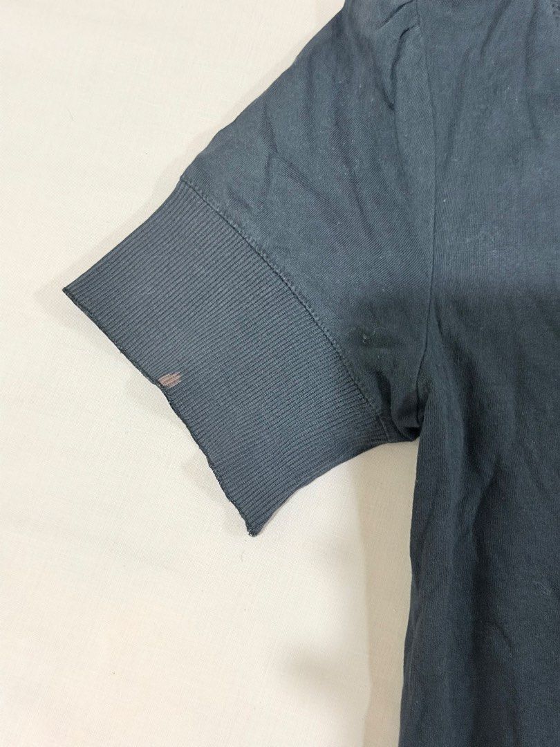 Espirit Grey Short Sleeve Button Cardigan V-Neck (Category: Blouses) located in Paranaque City. Submitted by hannahking36 (Listing ID 1469552632, Image 3). Description: - Brand: Esprit - Color: Dark grey - Material: Soft cotton blend - Style: Short sleeves, V-neckline, front button closure - Details: Wide ribbed hem and cuffs, small metal brand logo tag near the bottom - Flaw: Noticeable small reddish stain on the left sleeve cuff.