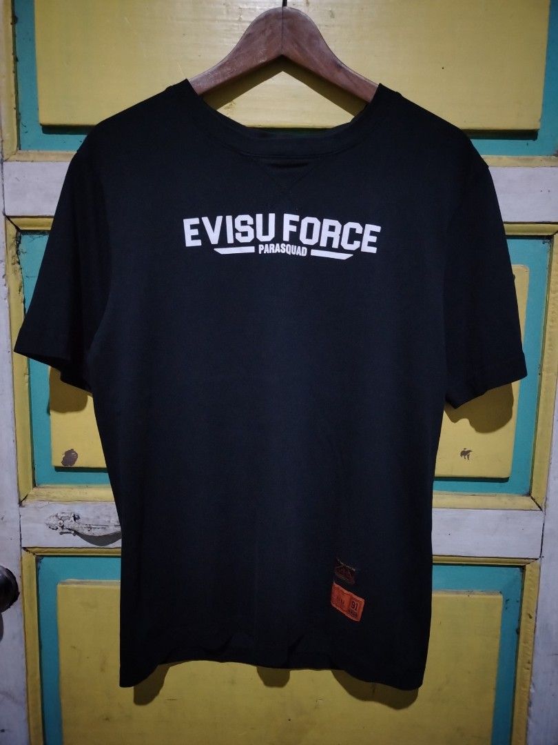 Evisu Force Parasquad Black Graphic T-Shirt (Category: Tshirts & Polo Shirts ) located in Caloocan City. Submitted by vincefresn21903 (Listing ID 1469500157, Image 1). Description: - Brand: Evisu - Model: Force Parasquad Tee - Color: Black - Size: Large (L) - Material: Comfortable cotton - Details: Bold white chest graphic, orange tag near hem, colorful embroidered patches across back shoulders, contrast stitching on inner collar - Condition: Exc