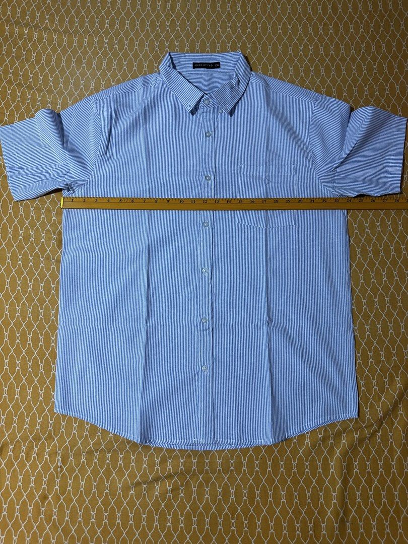 Executive Blue Striped Short Sleeve Button Down Shirt XXL (Category: Tshirts & Polo Shirts ) located in Quezon City. Submitted by breakstuf50 (Listing ID 1469473056, Image 3). Description: - Brand: Executive - Size: XXL - Design: Blue and white vertical stripes - Features: Left chest pocket, crisp collar, and button-front closure - Measurements: Length ~31.5 inches, Chest width ~25 inches across - Versatile: Perfect for casual wear or the office 