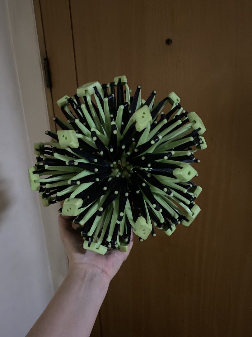 Expanding geometric sphere toy expandable breathing ball (Category: Educational & Learning Toys) located in Mandaluyong City. Submitted by mommykondo (Listing ID 1469465524, Image 1). Description: - Type: Large expanding geometric sphere toy - Colors: Black and lime green plastic pieces - Function: Collapses flat or expands into a massive geometric ball - Use: Fun fidget toy or cool desk display - Condition: Works smoothly, clean parts, and no br