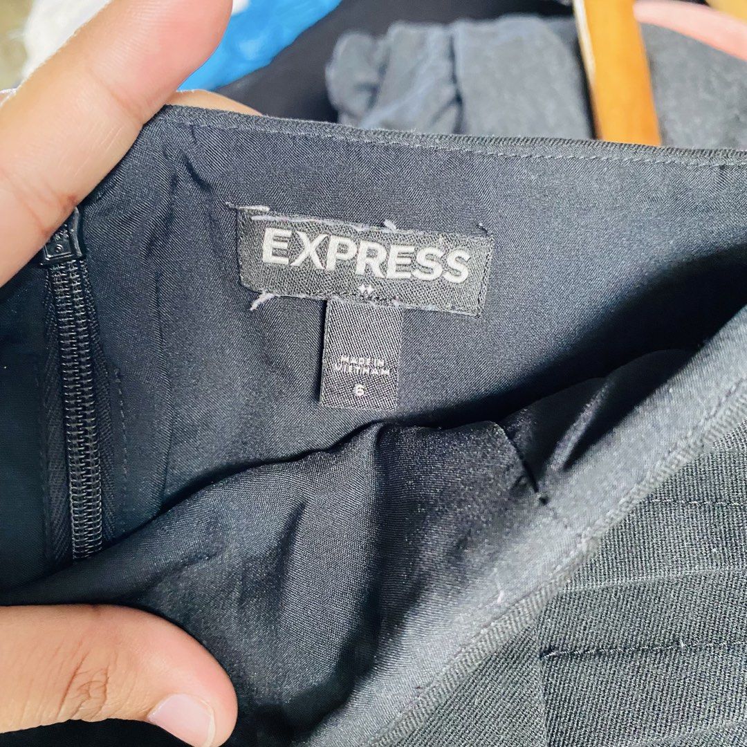 Express Black Pencil Skirt (Category: Skirts) located in Caloocan City. Submitted by lovemyclothes21 (Listing ID 1469407153, Image 2). Description: - Color: Classic Black - Size: 6 (Waist: approx. 30", Length: 21") - Style: Classic pencil cut, ideal for office wear and formal events - Details: Clean solid color with subtle pleated side accents near the waistband - Closure: Hidden side zipper.