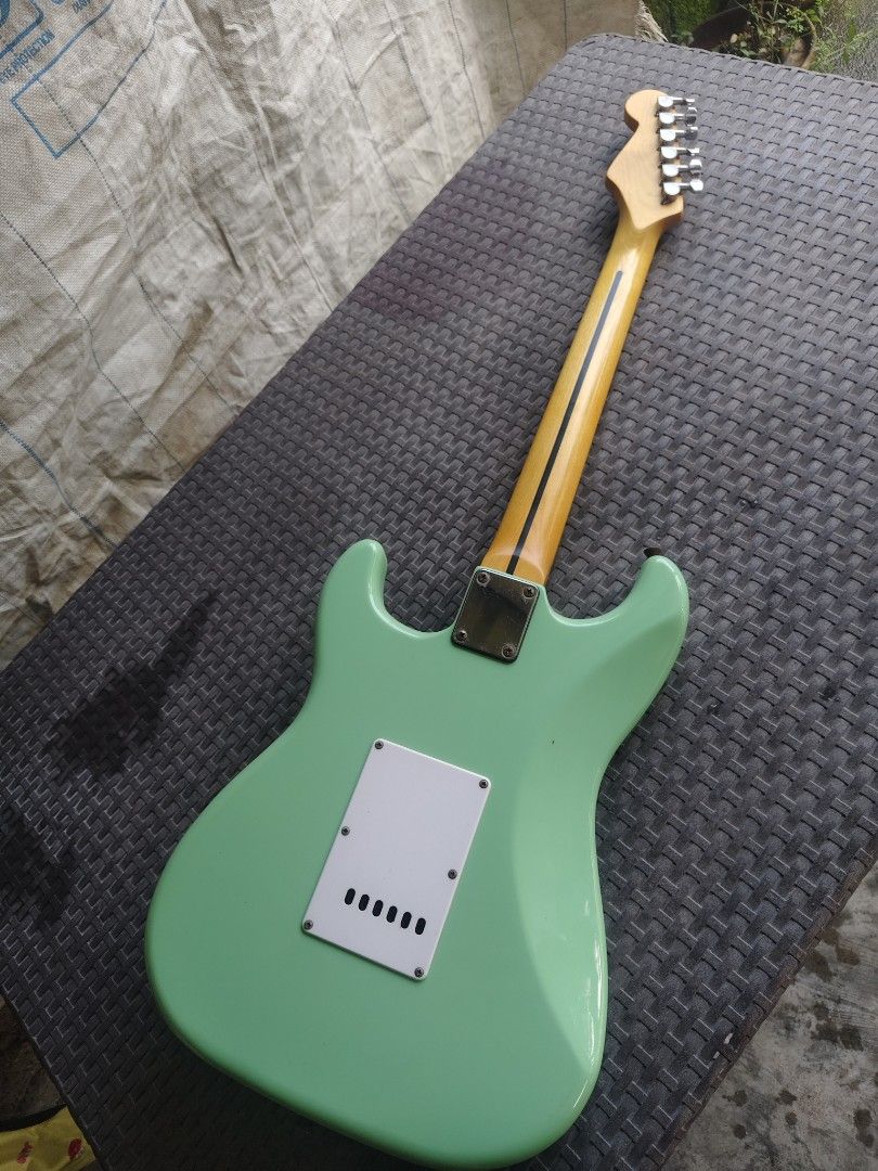 Fender Strat Mint Green copy (Category: Musical Instruments) located in Manila. Submitted by donsantiag93175 (Listing ID 1469401025, Image 3). Description: - For sale Fender Stratocaster copy Low action With Trust rod - Finish: Bright Mint Green with white pickguard and knobs - Neck & Fretboard: Maple with classic skunk stripe - Pickups: 3-single-coil setup for versatile tone - Hardware: Standard tremolo bridge (whammy bar included) and standard 