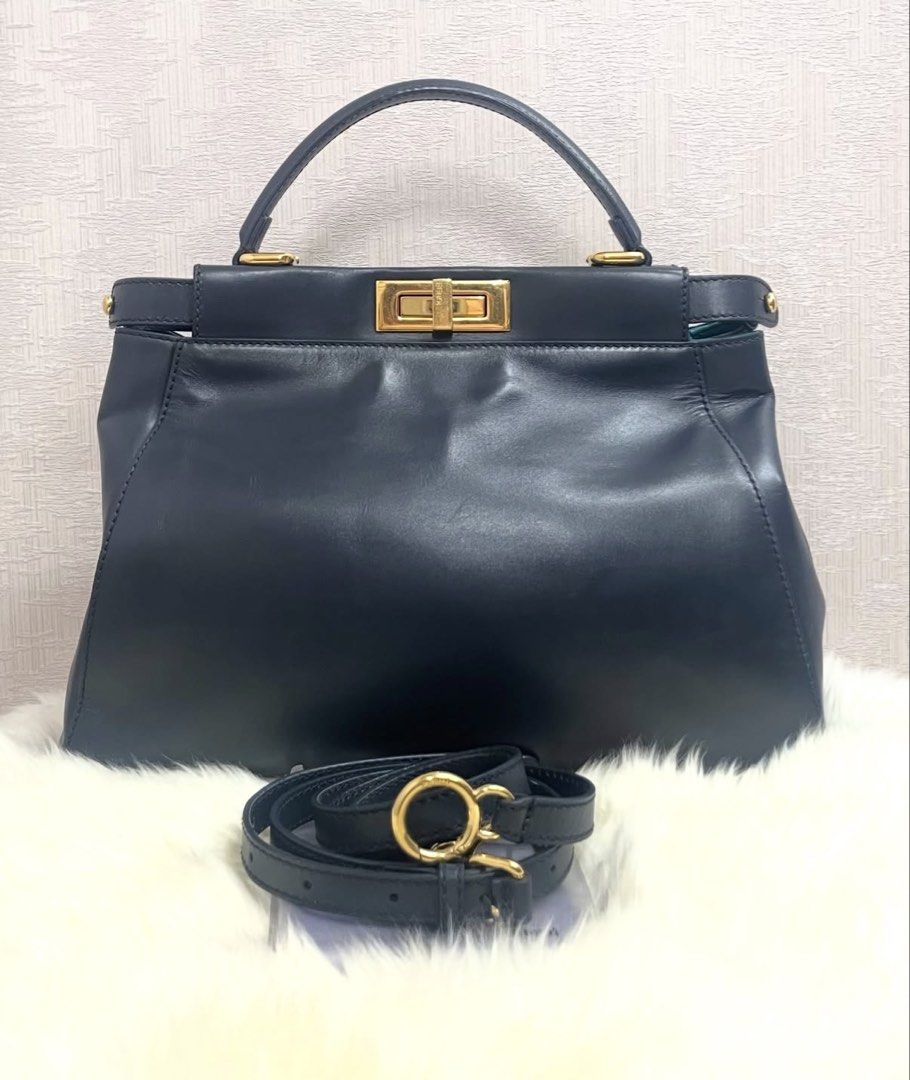 Fendi Peekaboo Medium Leather Bag (Category: Luxury Bags & Wallets) located in Makati City. Submitted by dgcurated09 (Listing ID 1469568211, Image 1). Description: - Brand: Fendi - Model: Peekaboo - Color: Dark Navy exterior with a bold turquoise interior lining - Hardware: Gold-tone with secure turn-lock closures on both sides - Material: Premium leather - Strap: Single top handle plus an adjustable and removable shoulder strap - Details: Protec
