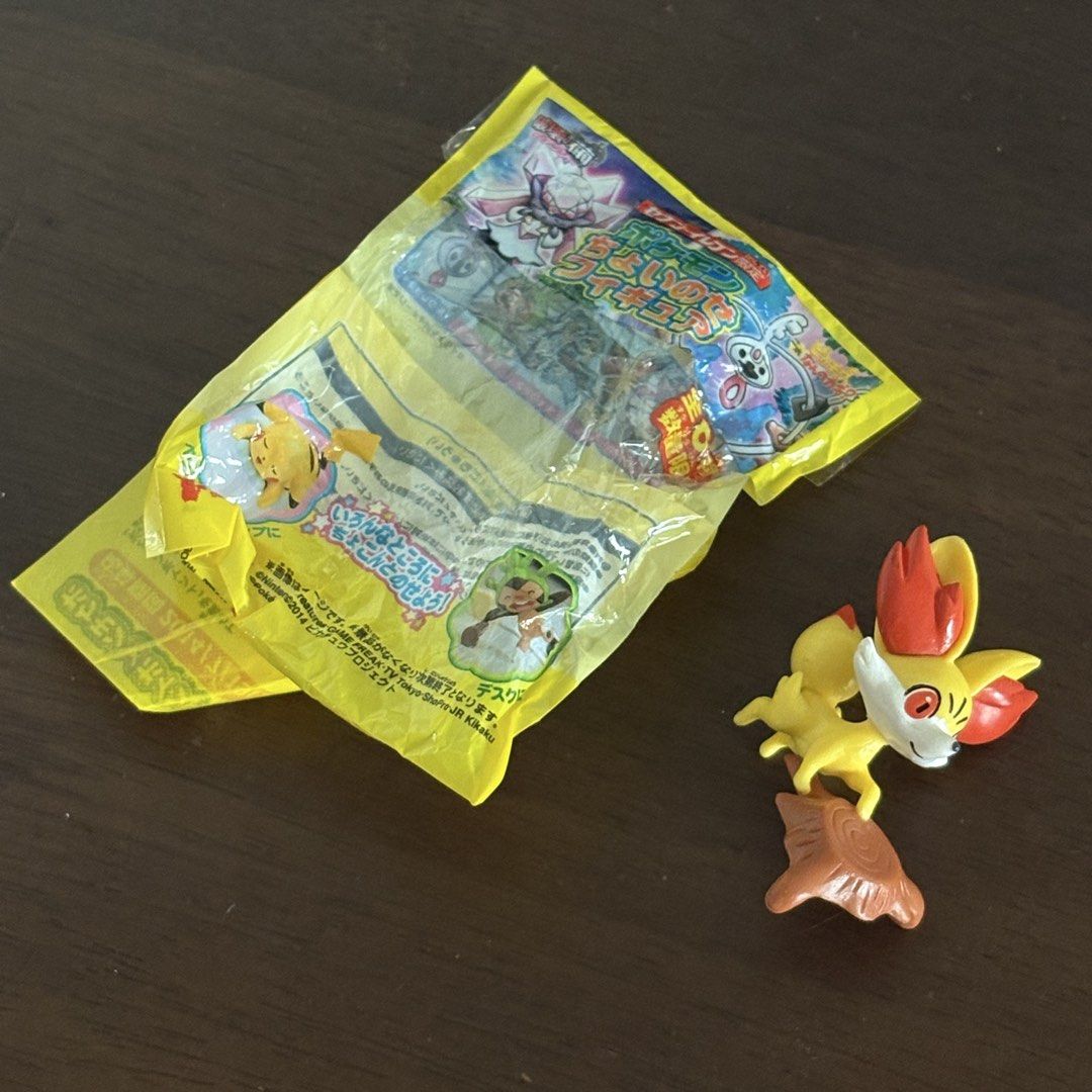 Fennekin Pokemon Figure with Tree Stump Base (Category: Figurines & Statues) located in Manila. Submitted by aobacafe (Listing ID 1469454560, Image 1). Description: - Character: Fennekin from Pokémon - Design: Bright yellow, orange, and white colors posed on a brown tree stump base - Inclusion: Original yellow foil packaging wrapper - Condition: Loose toy item, excellent for display or collection - Shipping: Fast shipping available across the Phi
