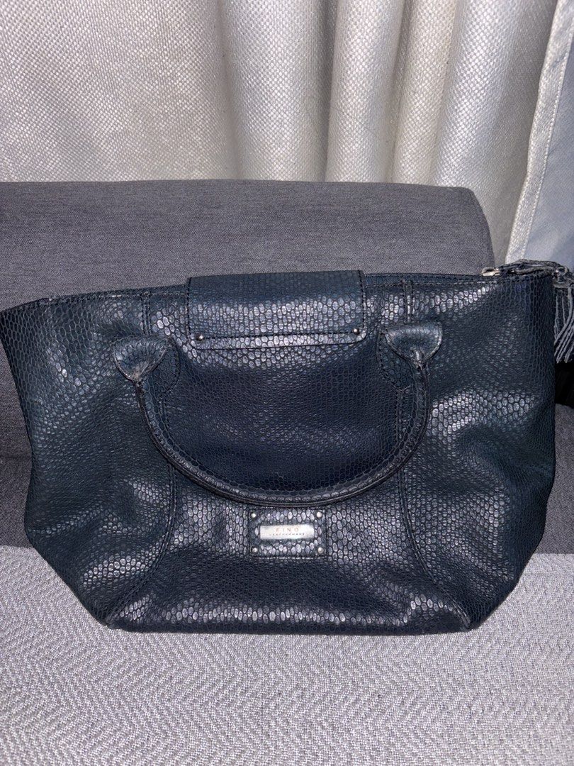 FINO Leatherware Davos Bag (Category: Shoulder Bags) located in Calamba. Submitted by victorangelogabriel (Listing ID 1469540407, Image 1). Description: • Embossed Leather: Crafted from genuine leather with a prominent, glossy reptile/snakeskin-embossed pattern. • Deep Colorway: Styled in a dark tone, typically available in charcoal black or deep navy blue. • Signature Logo Plate: Features a polished, rectangular silver-tone metal branding plate 
