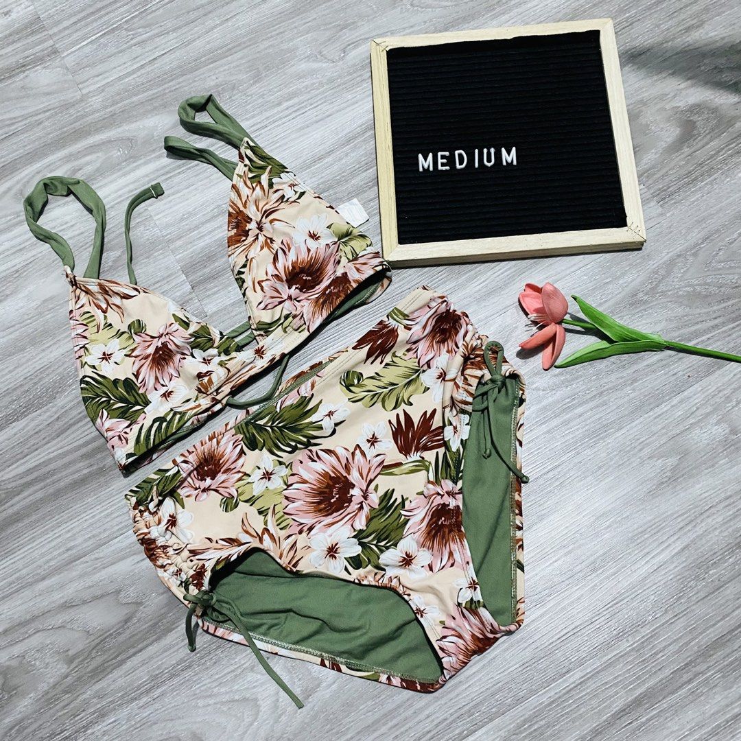 Floral Print Bikini Set (Category: Bikinis & Swimsuits) located in Caloocan City. Submitted by lovemyclothes21 (Listing ID 1469497104, Image 1). Description: - Style: Floral print bikini set - Colors: Beige and olive green with solid olive lining - Top: Triangle style with adjustable straps - Bottoms: High-waisted with adjustable side cinches and ties - Size: Medium (refer to board in photos) - Ideal for: Beach trips, pool parties, and tropical g
