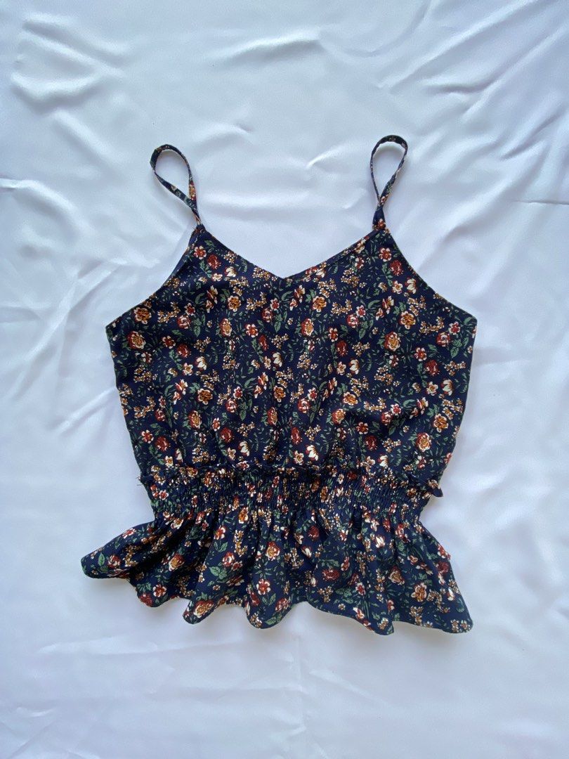Floral Print Cami and Solid Rust Tank Top Bundle (Category: Sleeveless) located in Cauayan City . Submitted by alt_olshop4 (Listing ID 1469539040, Image 1). Description: - Bundle includes 2 cute and lightweight casual camisoles - Piece 1: Navy blue base with tiny red/white flowers and a flattering smocked waist - Piece 2: Solid rust orange shade featuring thin straps and a slightly flared hem - Easy to mix and match for effortless everyday stylin