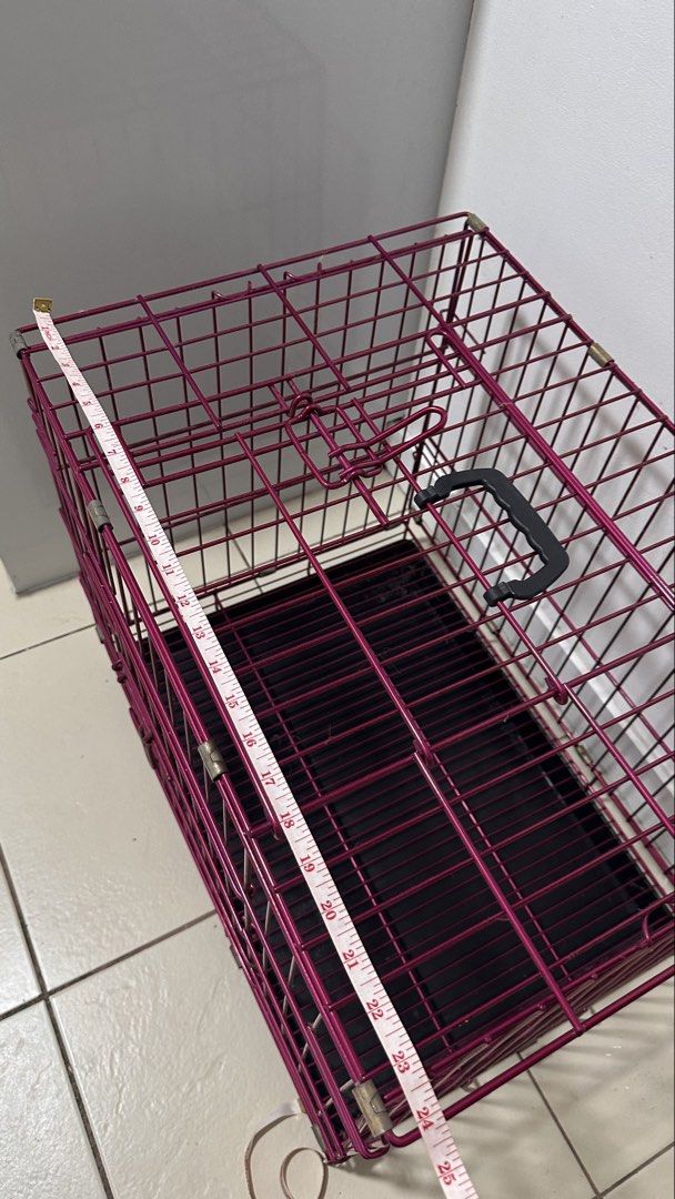 Foldable metal dog cage crate with removable tray (Category: Storage Boxes & Baskets) located in Taguig. Submitted by ImpulzBuyer (Listing ID 1469411126, Image 3). Description: - Color: Stylish pink metal wire - Size: Approx. 25 inches long x 18 inches wide - Design: Double doors with secure latches and convenient top carry handle - Convenience: Folds completely flat for easy storage and transport - Includes: Removable black plastic bottom tray f