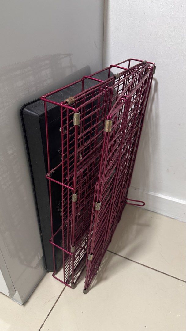 Foldable metal dog cage crate with removable tray (Category: Storage Boxes & Baskets) located in Taguig. Submitted by ImpulzBuyer (Listing ID 1469411126, Image 1). Description: - Color: Stylish pink metal wire - Size: Approx. 25 inches long x 18 inches wide - Design: Double doors with secure latches and convenient top carry handle - Convenience: Folds completely flat for easy storage and transport - Includes: Removable black plastic bottom tray f