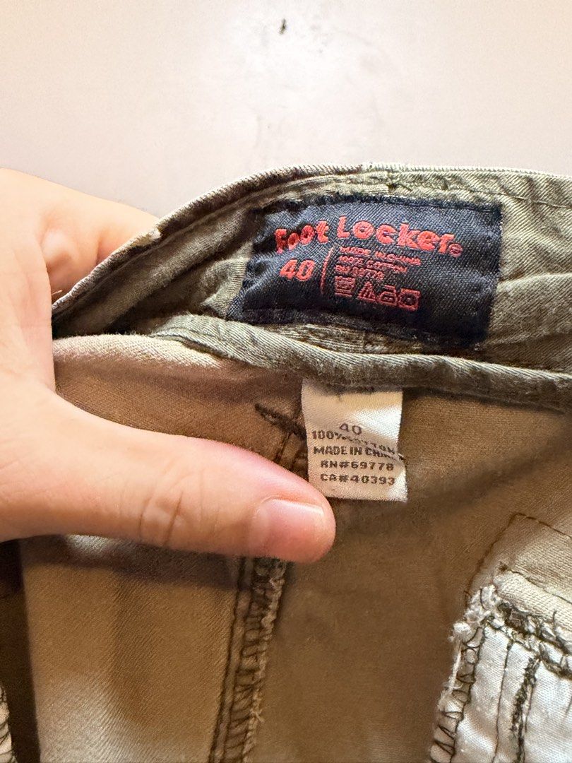 Foot Locker Camo Cargo Shorts Size 40 (Category: Shorts) located in Manila. Submitted by swiftgem.eeb06e (Listing ID 1469515494, Image 3). Description: - Brand: Foot Locker - Size: 40 - Material: 100% cotton for everyday comfort - Design: Classic green, brown, and tan camouflage print - Storage: Multiple functional pockets on sides and back - Condition: Minor wear spot near the front seam (check close-up photo) - Origin: Made in China - Size: 40 