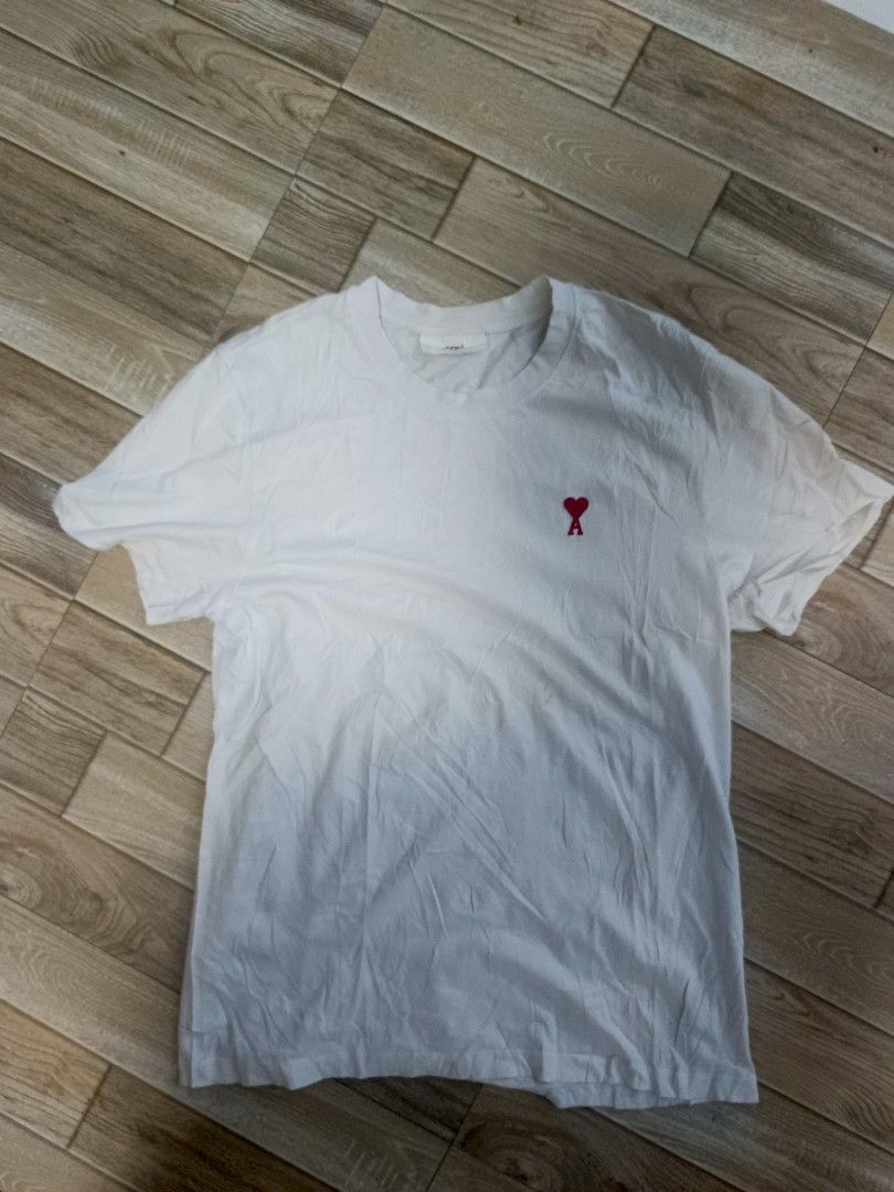 For sale (Category: Activewear) located in Koronadal. Submitted by 9509thrift (Listing ID 1469438362, Image 1). Description: AMI WHITE TEE GOOD CONDITION NO HIDDEN ISSUE NEED WASH LANG PO CAN DO J&T 680 +SF.