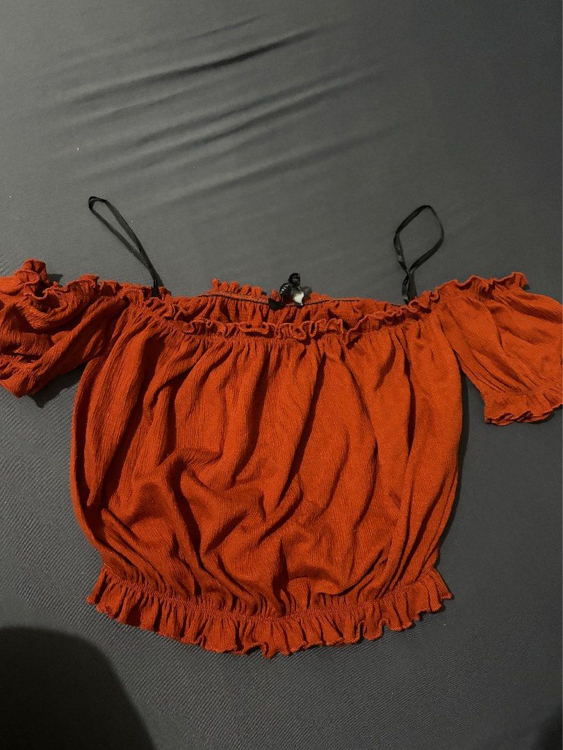 Forever 21 Off-Shoulder Orange Ruffle Blouse (Category: Blouses) located in Manila. Submitted by janna606 (Listing ID 1469545656, Image 1). Description: - Brand: Forever 21 - Color: Rust orange - Style: Off-shoulder crop blouse - Material: Textured lightweight fabric - Details: Ruffle trim along the top and bottom, plus short ruffled sleeves.
