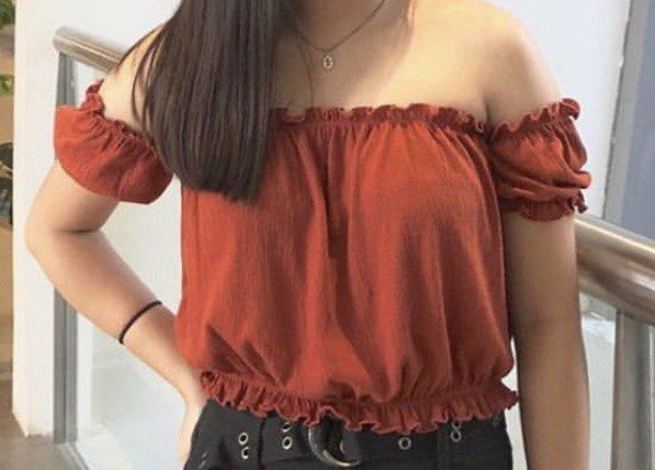 Forever 21 Off-Shoulder Orange Ruffle Blouse (Category: Blouses) located in Manila. Submitted by janna606 (Listing ID 1469545656, Image 2). Description: - Brand: Forever 21 - Color: Rust orange - Style: Off-shoulder crop blouse - Material: Textured lightweight fabric - Details: Ruffle trim along the top and bottom, plus short ruffled sleeves.