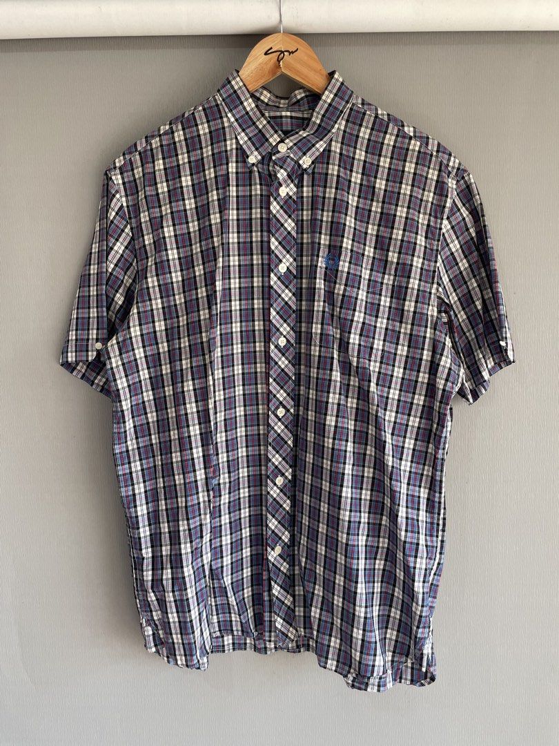 Fred Perry Plaid Short Sleeve Button Down Shirt Large (Category: Tshirts & Polo Shirts ) located in Mataasnakahoy. Submitted by zero4thrift (Listing ID 1469435634, Image 1). Description: - Brand: Fred Perry - Style: Short sleeve button-down shirt - Pattern: Multi-color plaid (Blue, White, Black, Red) - Size: L - Material: 100% Cotton (Made in China) - Features: Button-down collar, front button closure, and chest pocket with iconic embroidered lau