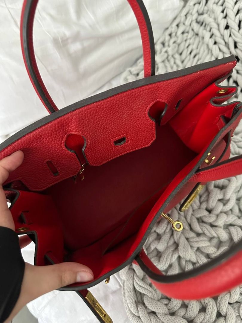 FREE birkin (Category: Luxury Bags & Wallets) located in Quezon City. Submitted by flipandfind (Listing ID 1469417934, Image 3). Description: - Brand: Hermès (NGA) - Style: Birkin Handbag - Material: Red textured leather (FAUX AND PEELING) - Hardware: Gold-tone - Features: Double top handles, front strap closure, matching red leather interior - Condition: Noticeable peeling and edge wear along the side gusset seam, with slight scuffs on the front