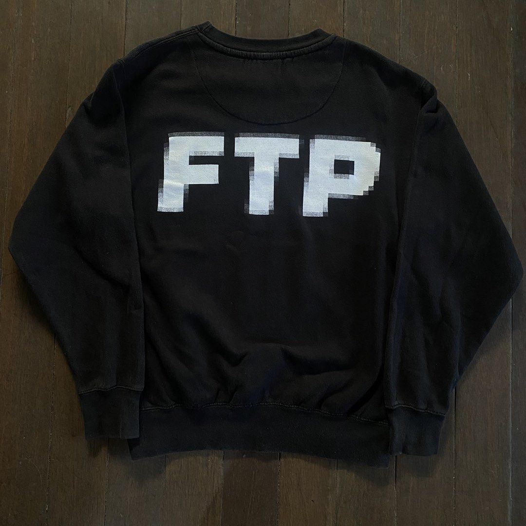 FUCK THE POPULATION pixel crewneck (Category: Coats, Jackets and Outerwear) located in Bayambang. Submitted by vision888 (Listing ID 1469456034, Image 3). Description: - Brand: FTP - Color: Black with white glitch text graphic (left chest and large on back) - Material: 80% cotton, 20% polyester blend - Details: Ribbed cuffs and hem - Condition: Gently worn with a stylish faded wash throughout from normal laundering.