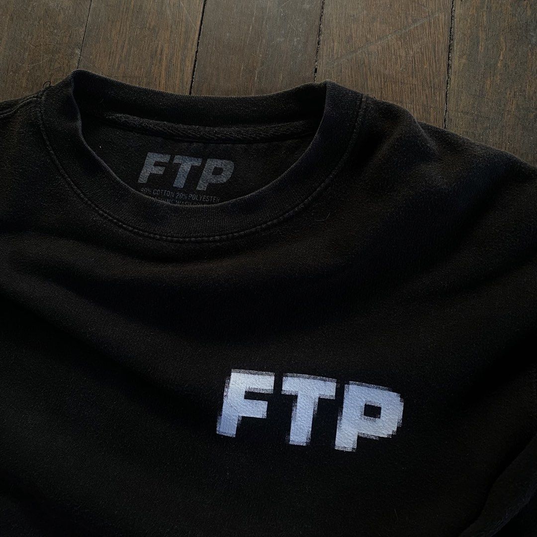 FUCK THE POPULATION pixel crewneck (Category: Coats, Jackets and Outerwear) located in Bayambang. Submitted by vision888 (Listing ID 1469456034, Image 2). Description: - Brand: FTP - Color: Black with white glitch text graphic (left chest and large on back) - Material: 80% cotton, 20% polyester blend - Details: Ribbed cuffs and hem - Condition: Gently worn with a stylish faded wash throughout from normal laundering.