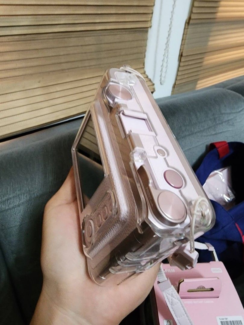 Fujifilm Instax Mini Evo Gentle Rose (Category: Cameras) located in Caloocan City. Submitted by angell_dsartes (Listing ID 1469434460, Image 3). Description: - Model: Fujifilm Instax Mini Evo Hybrid Instant Camera - Color: Gentle Rose - Inclusions: Original pink box, fitted clear protective hard case, matching pink strap, blue Instax pouch bag, and beaded charm strap - Condition: Complete set as pictured, ready to use - Perfect all-in-one bundle 