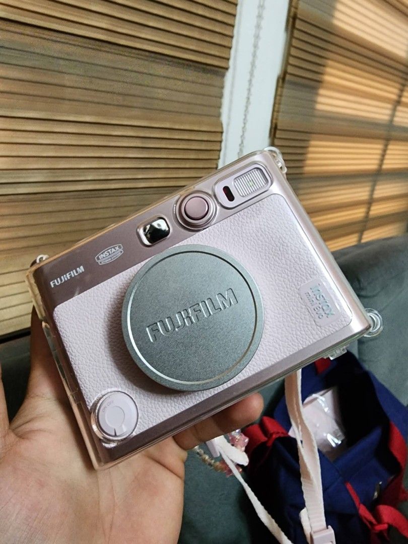 Fujifilm Instax Mini Evo Gentle Rose (Category: Cameras) located in Caloocan City. Submitted by angell_dsartes (Listing ID 1469434460, Image 2). Description: - Model: Fujifilm Instax Mini Evo Hybrid Instant Camera - Color: Gentle Rose - Inclusions: Original pink box, fitted clear protective hard case, matching pink strap, blue Instax pouch bag, and beaded charm strap - Condition: Complete set as pictured, ready to use - Perfect all-in-one bundle 
