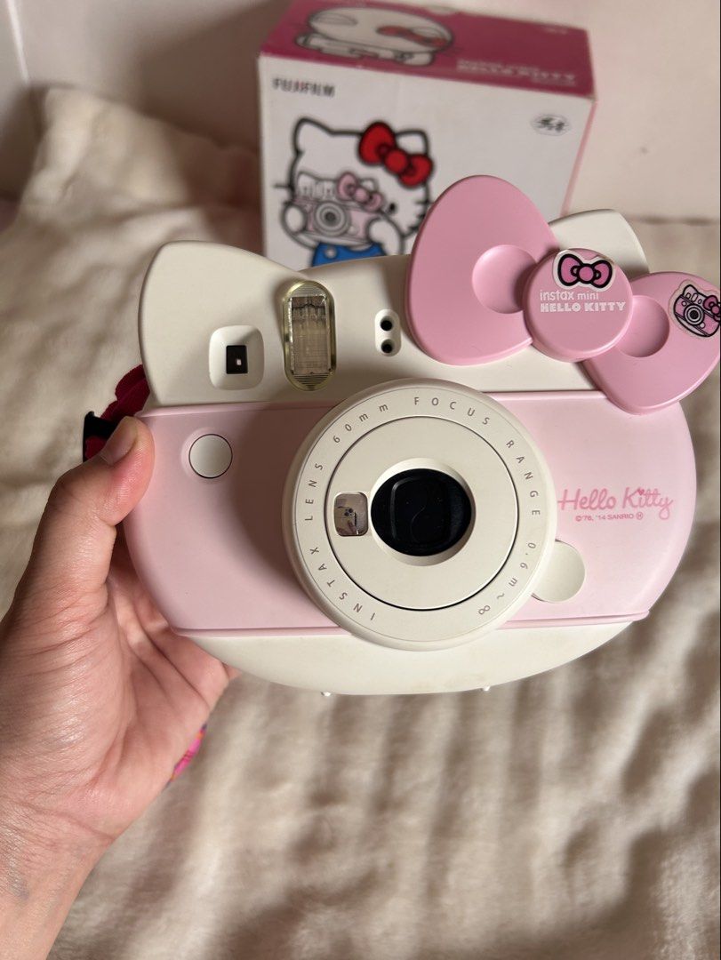 Fujifilm Instax Mini Hello Kitty Instant Camera Pink (Category: Cameras) located in Marikina City. Submitted by chayassy (Listing ID 1469453435, Image 2). Description: - Authentic Fujifilm Instax Mini Kitty instant camera (pink and white) - Shaped like Kitty with her signature pink bow - Tested and 100% fully functional - Clean battery compartment (batteries not included) - Inclusions: Original box, black drawstring pouch, pink plaid strap, user 