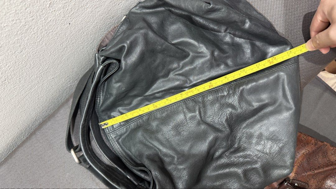 Furla Black Leather Hobo Bag (Category: Cross-body Bags) located in Bulacan. Submitted by surewinstuff (Listing ID 1469553513, Image 3). Description: Pre-loved Furla bag in black genuine leather with a soft, slouchy silhouette and adjustable shoulder strap. Features a zippered interior pocket, patterned lining, and magnetic snap closure. Shows visible creasing, scratches, and signs of use on the leather and hardware. Please check all photos for t