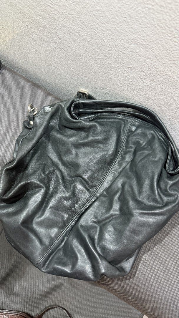 Furla Black Leather Hobo Bag (Category: Cross-body Bags) located in Bulacan. Submitted by surewinstuff (Listing ID 1469553513, Image 1). Description: Pre-loved Furla bag in black genuine leather with a soft, slouchy silhouette and adjustable shoulder strap. Features a zippered interior pocket, patterned lining, and magnetic snap closure. Shows visible creasing, scratches, and signs of use on the leather and hardware. Please check all photos for t