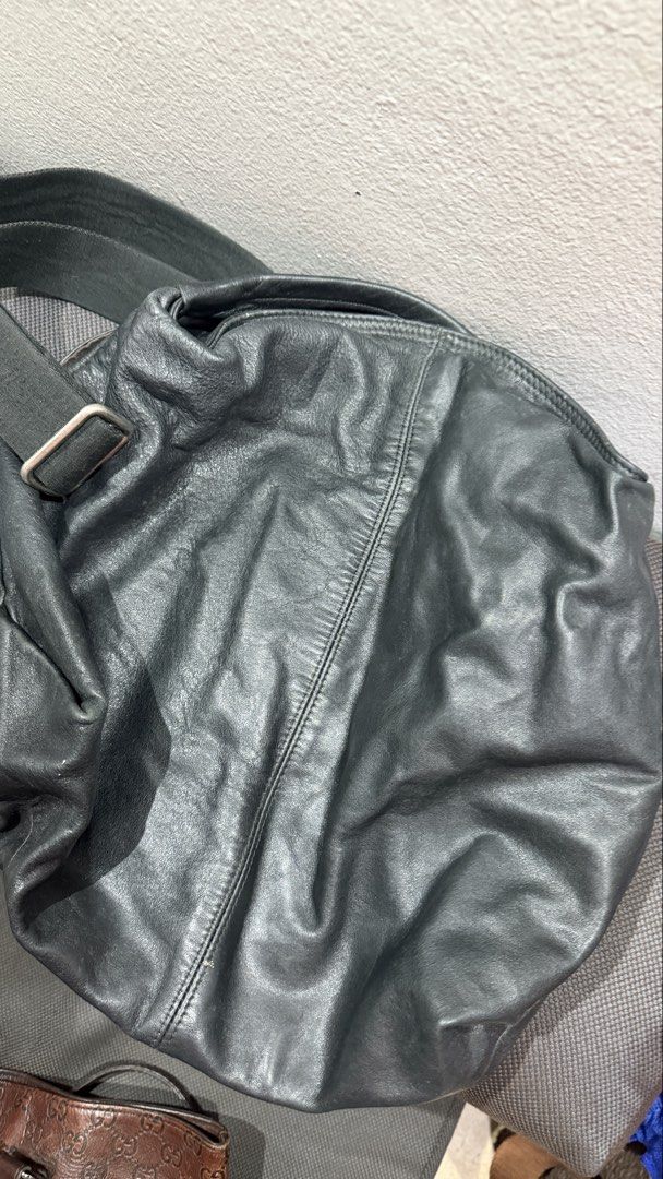 Furla Black Leather Hobo Bag (Category: Cross-body Bags) located in Bulacan. Submitted by surewinstuff (Listing ID 1469553513, Image 2). Description: Pre-loved Furla bag in black genuine leather with a soft, slouchy silhouette and adjustable shoulder strap. Features a zippered interior pocket, patterned lining, and magnetic snap closure. Shows visible creasing, scratches, and signs of use on the leather and hardware. Please check all photos for t