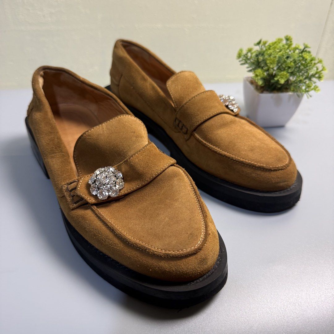 GANNI SUEDE LOAFERS (Category: Loafers) located in Bago City. Submitted by g___shop (Listing ID 1469499489, Image 2). Description: - Authentic - Type: Slip-on loafers - Color/Material: Tan brown suede with smooth tan lining - Sole: Chunky black platform with low block heels - Accents: Clear crystal rhinestone embellishment on the front strap - Condition: Clean uppers with minimal wear on soles - Perfect for: Adding a chic and sparkly touch to you