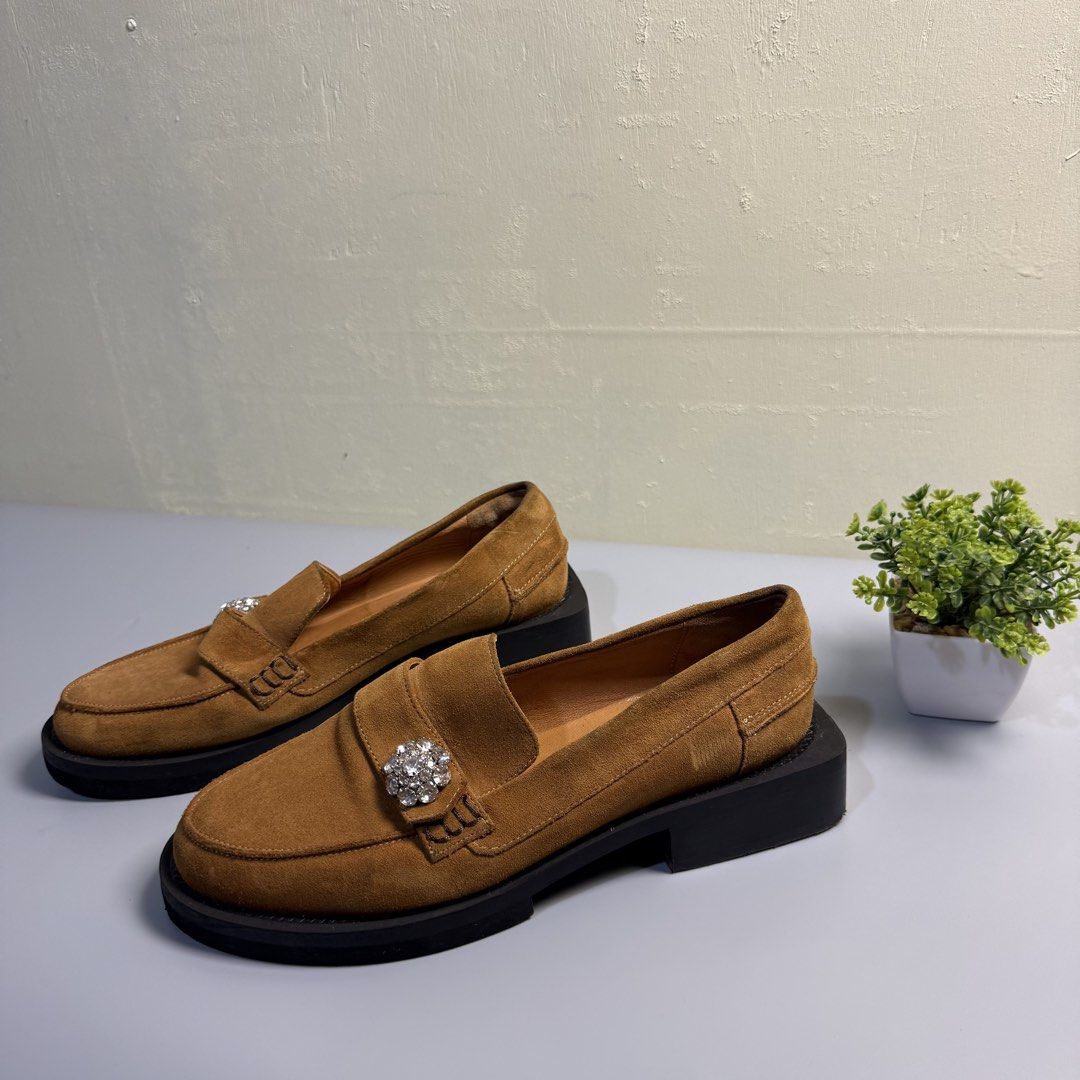 GANNI SUEDE LOAFERS (Category: Loafers) located in Bago City. Submitted by g___shop (Listing ID 1469499489, Image 3). Description: - Authentic - Type: Slip-on loafers - Color/Material: Tan brown suede with smooth tan lining - Sole: Chunky black platform with low block heels - Accents: Clear crystal rhinestone embellishment on the front strap - Condition: Clean uppers with minimal wear on soles - Perfect for: Adding a chic and sparkly touch to you