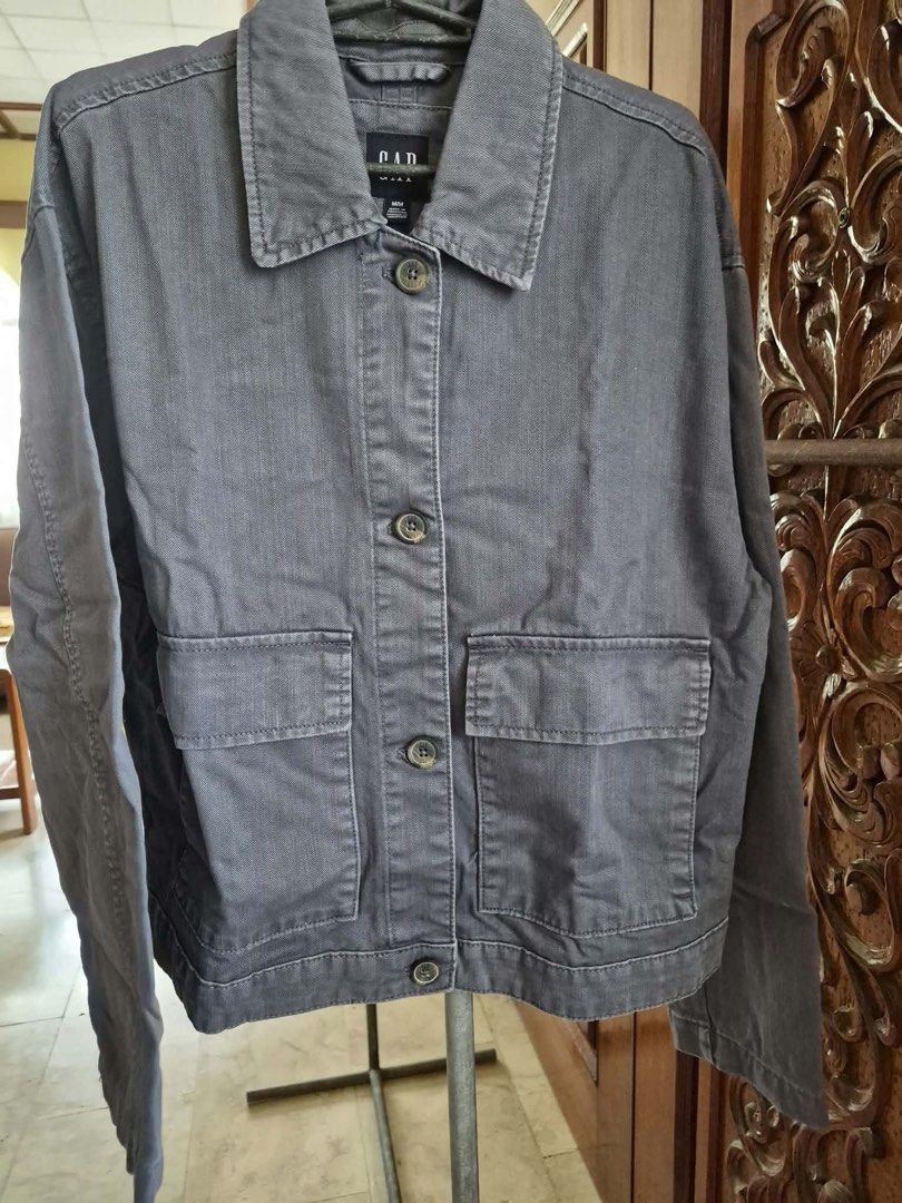 GAP Gray Cotton Button-Up Jacket Size M (Category: Coats, Jackets and Outerwear) located in Manila. Submitted by freestone_f18729 (Listing ID 1469421631, Image 1). Description: - Brand: GAP - Size: M - Material: 100% Cotton - Color: Solid charcoal gray - Features: Button-up front with branded buttons, collared neckline with hanging loop, two front chest patch pockets - Condition: Great staple piece for casual wear - Origin: Made in Pakistan Never