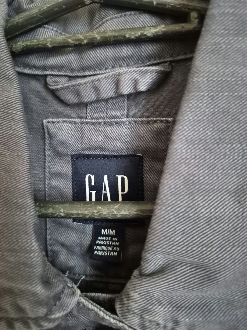 GAP Gray Cotton Button-Up Jacket Size M (Category: Coats, Jackets and Outerwear) located in Manila. Submitted by freestone_f18729 (Listing ID 1469421631, Image 2). Description: - Brand: GAP - Size: M - Material: 100% Cotton - Color: Solid charcoal gray - Features: Button-up front with branded buttons, collared neckline with hanging loop, two front chest patch pockets - Condition: Great staple piece for casual wear - Origin: Made in Pakistan Never