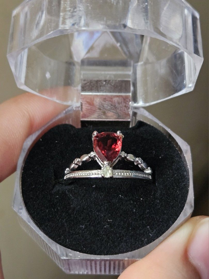 Garnet Silver Plated Ring (Category: Rings) located in Quezon City. Submitted by slipcattt (Listing ID 1469418567, Image 2). Description: - Silver plated ring featuring a pear-cut Garnet stone - Unique asymmetrical band with a textured double row on one side and beaded accents on the other - Adjustable size - Includes a clear octagonal plastic display box for safe storage or gifting.