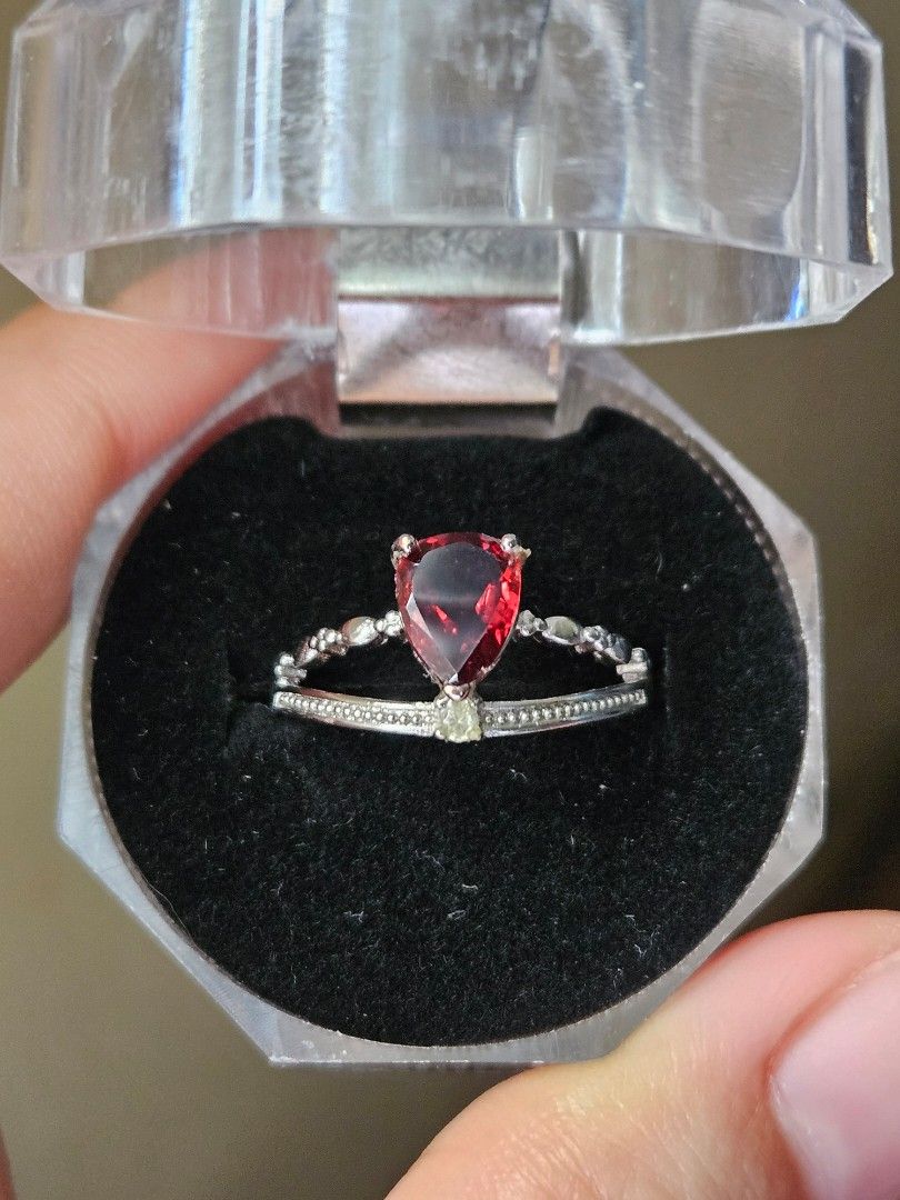 Garnet Silver Plated Ring (Category: Rings) located in Quezon City. Submitted by slipcattt (Listing ID 1469418567, Image 1). Description: - Silver plated ring featuring a pear-cut Garnet stone - Unique asymmetrical band with a textured double row on one side and beaded accents on the other - Adjustable size - Includes a clear octagonal plastic display box for safe storage or gifting.