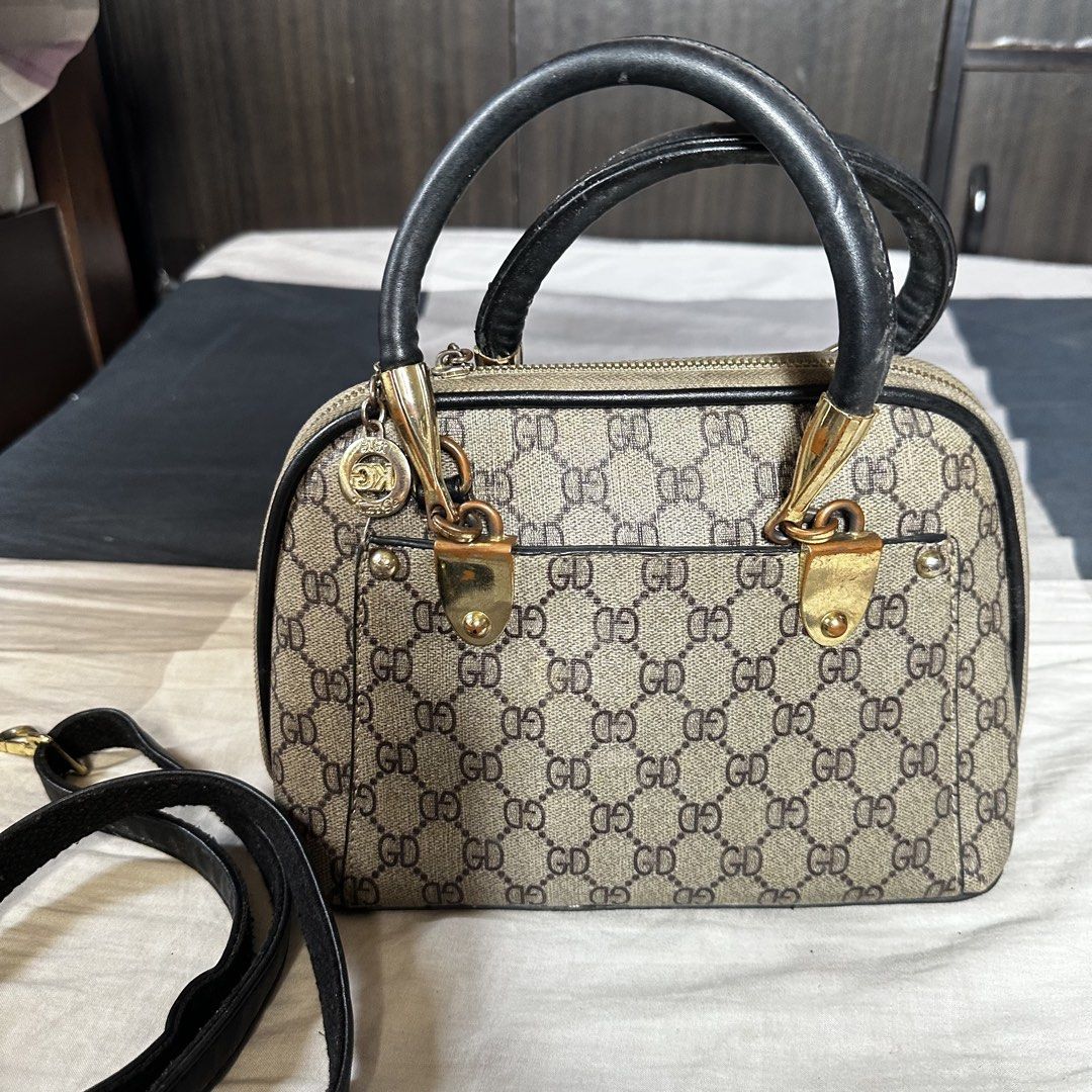 GD monogram print handbag with top handle and strap Inspired (Category: Luxury Bags & Wallets) located in Manila. Submitted by daintywears (Listing ID 1469446321, Image 2). Description: needs cleaning. manage expectations, inspired. - Trendy monogram print with GD pattern - Structured dome silhouette with secure zip closure - Dual top handles plus a detachable black shoulder strap - Elegant gold-tone hardware accents - Compact size, perfect for d