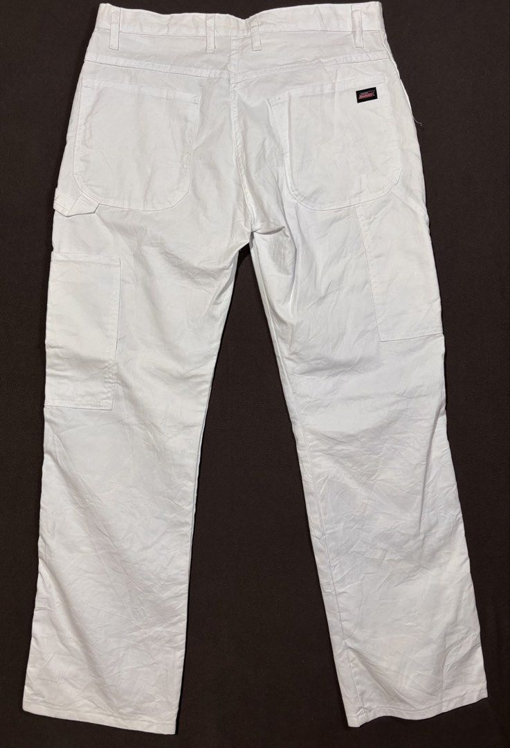 Genuine Dickies White Carpenter Pants (Category: Jeans) located in Mabalacat. Submitted by _limitlessfashion (Listing ID 1469425238, Image 3). Description: - Brand: Genuine Dickies - Color: Classic White - Size 34-35 - Length 42 - Hem 9.5 - No issue, need wash only - Material: Heavy-duty, durable cotton blend - Fit: Relaxed fit for all-day comfort - Features: Multiple side utility pockets, hammer loop, branded black metal button closure, and wove