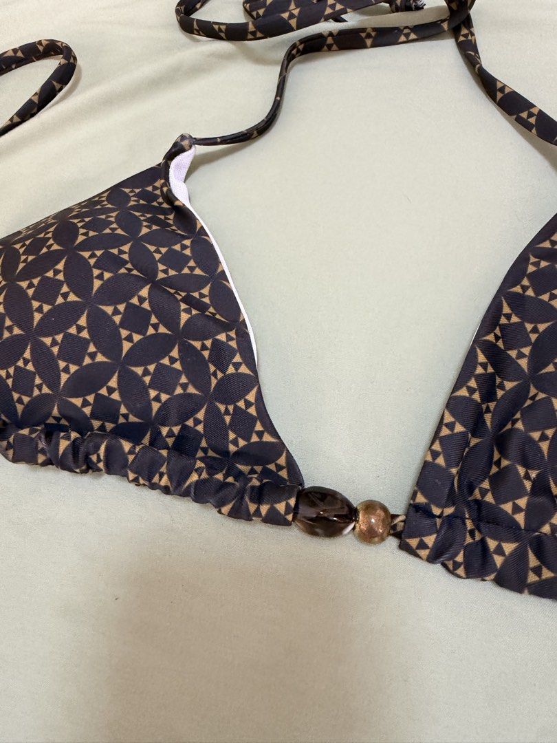 Geometric Triangle Bikini Set with Gold Bead Details (Category: Bikinis & Swimsuits) located in Makati City. Submitted by andzr. (Listing ID 1469543229, Image 3). Description: - Brand new with tags (never worn) - Stylish dark brown and tan geometric print - Triangle top and adjustable tie-side bottoms - Chic shiny gold and dark bead details on string ends - Fully lined with comfortable white inner lining.