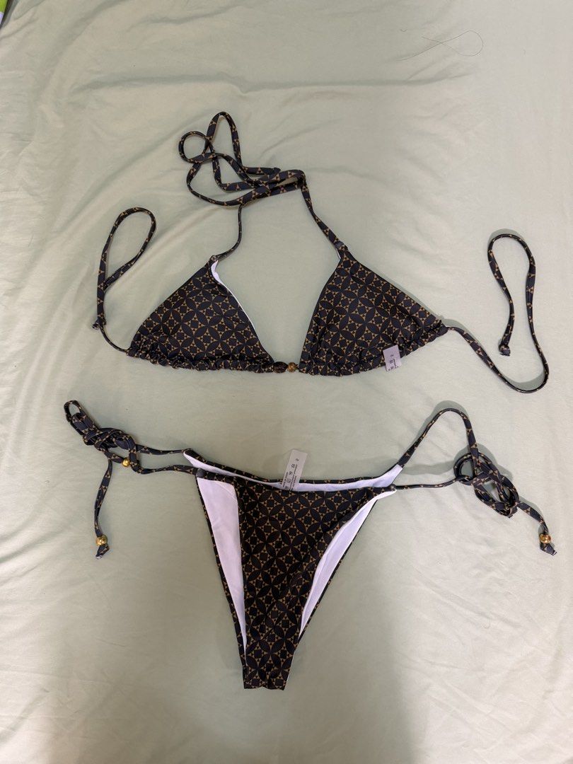 Geometric Triangle Bikini Set with Gold Bead Details (Category: Bikinis & Swimsuits) located in Makati City. Submitted by andzr. (Listing ID 1469543229, Image 1). Description: - Brand new with tags (never worn) - Stylish dark brown and tan geometric print - Triangle top and adjustable tie-side bottoms - Chic shiny gold and dark bead details on string ends - Fully lined with comfortable white inner lining.