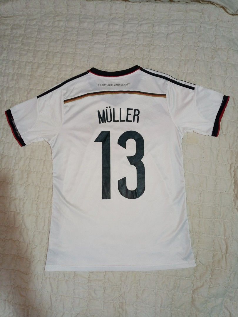 Germany World Cup Home Jersey Müller 13 (Category: Activewear) located in Allen. Submitted by milyonaryung_gipit (Listing ID 1469441302, Image 2). Description: - Official Germany home shirt from the 2014 World Cup winning campaign - Features Thomas Müller #13 printing on the back - Iconic white base with the red and black chest chevron - Lightweight Adidas Climacool material - Size: S - Perfect for DFB fans and jersey collectors - 100% authentic.
