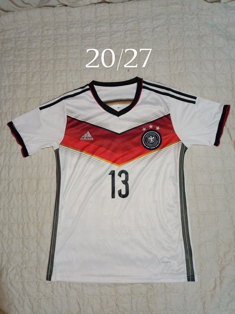 Germany World Cup Home Jersey Müller 13 (Category: Activewear) located in Allen. Submitted by milyonaryung_gipit (Listing ID 1469441302, Image 1). Description: - Official Germany home shirt from the 2014 World Cup winning campaign - Features Thomas Müller #13 printing on the back - Iconic white base with the red and black chest chevron - Lightweight Adidas Climacool material - Size: S - Perfect for DFB fans and jersey collectors - 100% authentic.