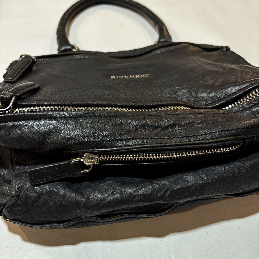 Givenchy Pandora Black Leather Handbag (Category: Luxury Bags & Wallets) located in Dipolog. Submitted by dionato (Listing ID 1469422733, Image 3). Description: - Brand: Givenchy Pandora - Material: Supple black crumpled leather with a structured base - Hardware: Silver-tone with front and top zip closures - Handle: Single top handle design - Interior: Fabric-lined with a zip pocket and 'Givenchy Made in Italy' leather tag - Condition: Minor sign