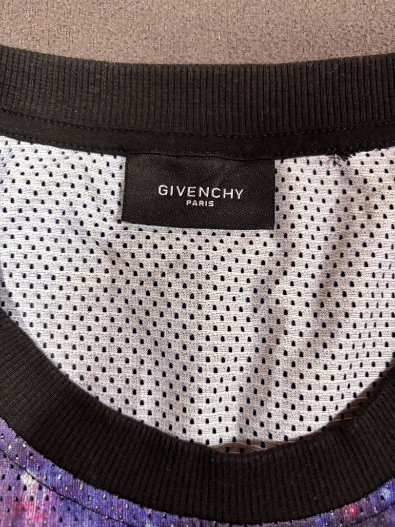 Givenchy Yeezy 77 Space Graphic Tank Top (Category: Sleeveless) located in Mabalacat. Submitted by _limitlessfashion (Listing ID 1469406956, Image 3). Description: - Brand: Givenchy - Size Large on tag - Length 28 - Width 18 - Style: Basketball mesh tank top - Color/Design: Purple space galaxy print - Front Detail: All-Seeing Eye pyramid graphic with 'DON'T TRUST ANYONE' text - Back Detail: 'YEEZY' and number 77 in bold white lettering - Trim: Ri
