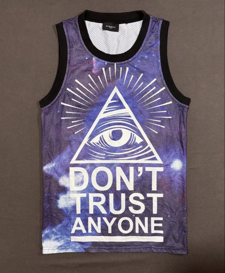 Givenchy Yeezy 77 Space Graphic Tank Top (Category: Sleeveless) located in Mabalacat. Submitted by _limitlessfashion (Listing ID 1469406956, Image 1). Description: - Brand: Givenchy - Size Large on tag - Length 28 - Width 18 - Style: Basketball mesh tank top - Color/Design: Purple space galaxy print - Front Detail: All-Seeing Eye pyramid graphic with 'DON'T TRUST ANYONE' text - Back Detail: 'YEEZY' and number 77 in bold white lettering - Trim: Ri