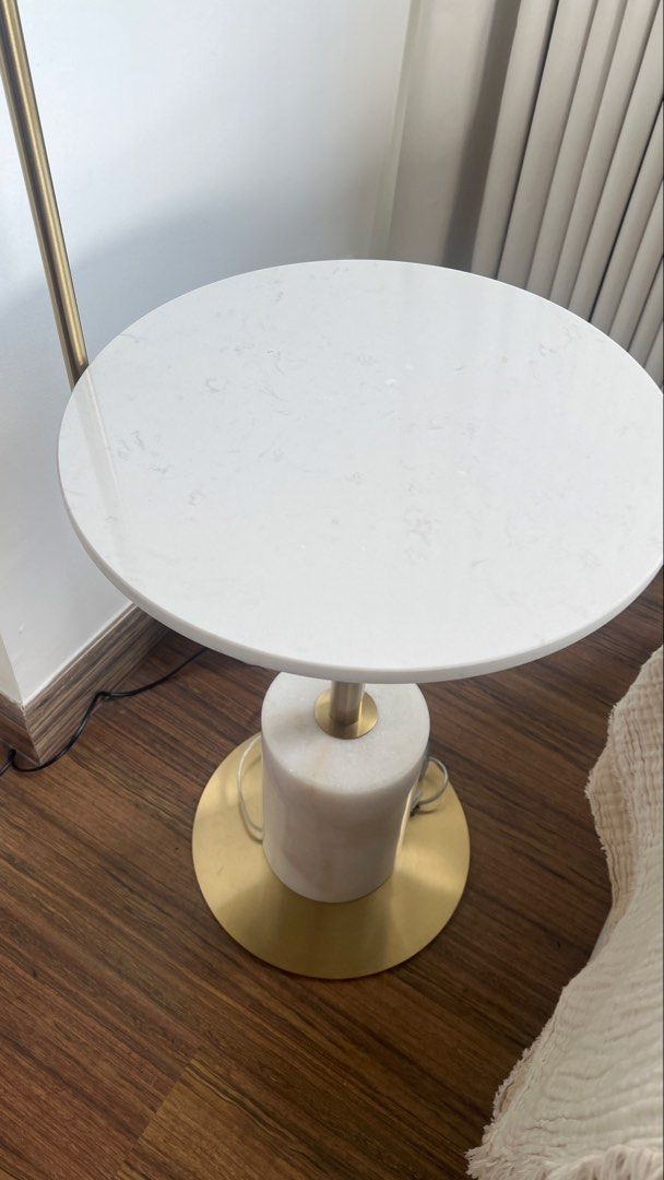 Gold Floor Lamp with White Marble Side Table (Category: Lighting) located in Pasig City. Submitted by thestylesisters (Listing ID 1469421065, Image 3). Description: - 2-in-1 design: Combines a reading light and a small coffee table - Space-saving: Takes up very little floor space, perfect beside a sofa or bed - Elegant aesthetic: Gold tone metal finish with a white marble top - Sturdy build: Features a heavy cylindrical marble base - Adjustable l