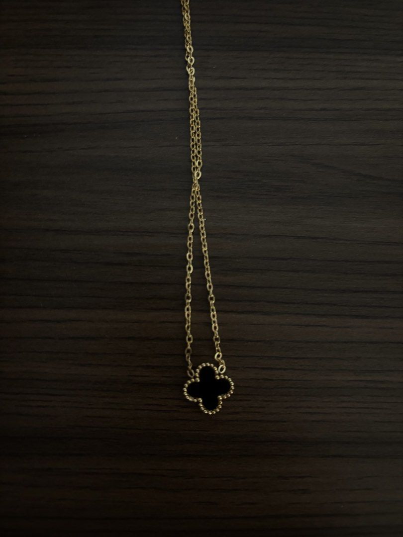 Gold Four-Leaf Clover Black Pendant Necklace (Category: Necklaces) located in San Juan City. Submitted by hellokitty_454 (Listing ID 1469462294, Image 2). Description: - Elegant gold chain necklace with a black four-leaf clover pendant - Features a delicate beaded trim around the clover motif - Secured with a simple lobster clasp and extension links - Sits gracefully right on the collarbone - Perfect, versatile piece for daily wear - with box.
